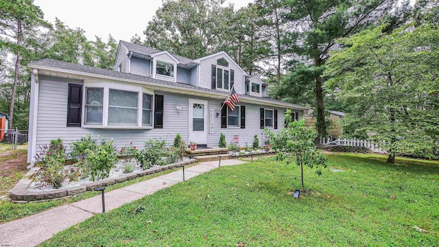 cape cod home with a front lawn