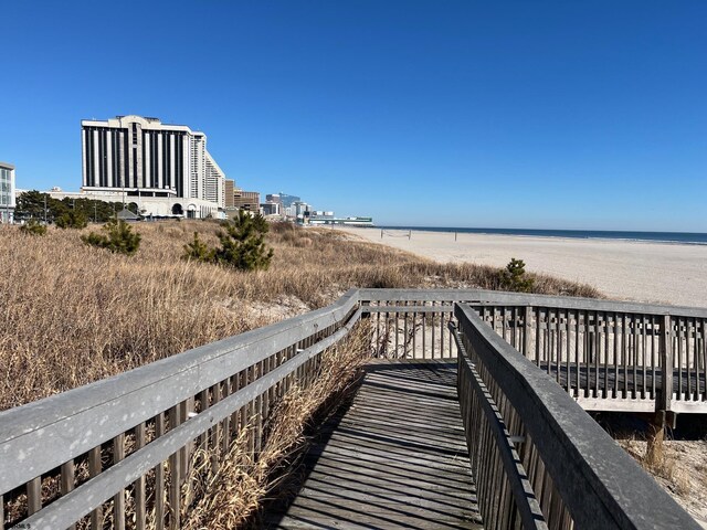 view of home's community featuring a water view and a view of the beach