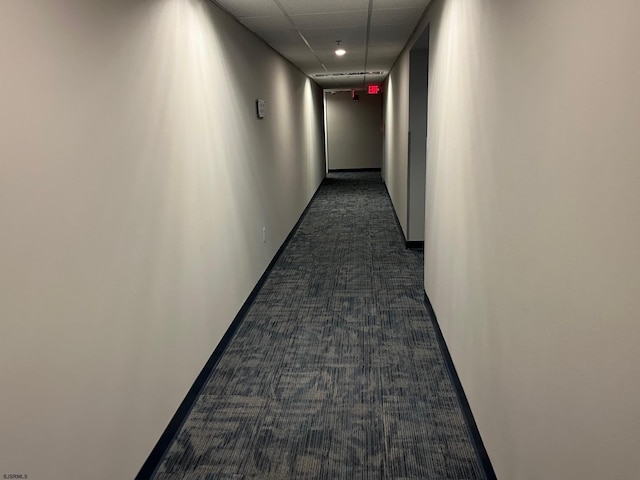 corridor featuring dark colored carpet