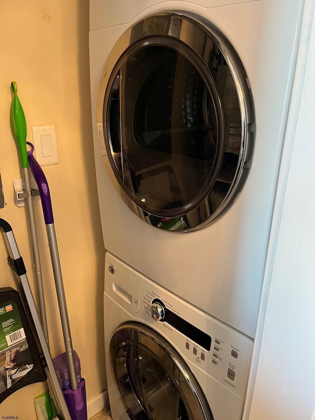 laundry room with stacked washer and clothes dryer