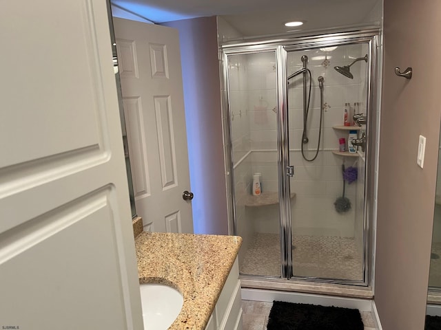 bathroom with walk in shower and vanity