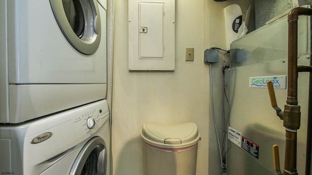 laundry room featuring stacked washer and clothes dryer and electric panel