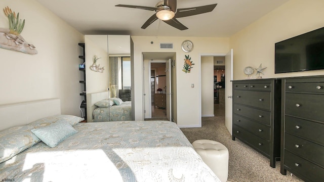 carpeted bedroom with ceiling fan and a closet