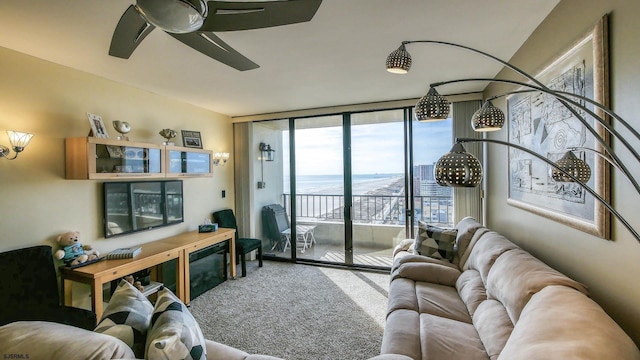 carpeted living room with a wall of windows and ceiling fan