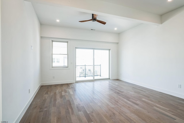 unfurnished room featuring beam ceiling, hardwood / wood-style floors, and ceiling fan