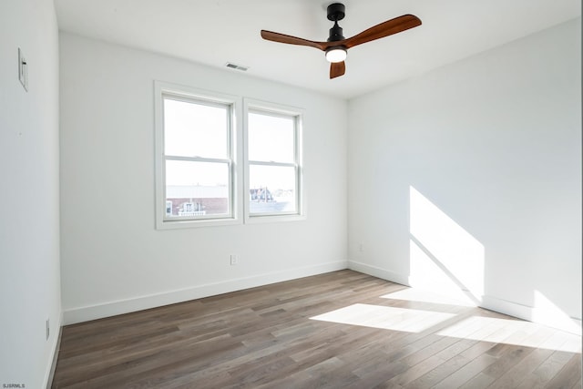 empty room featuring hardwood / wood-style flooring and ceiling fan