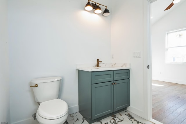 bathroom with vanity, ceiling fan, lofted ceiling, and toilet