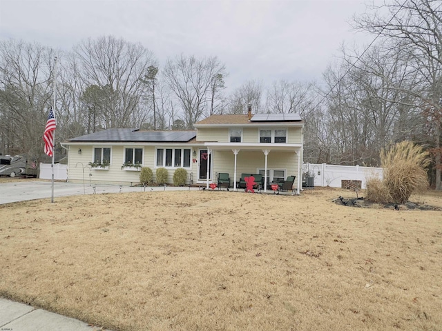 view of front property featuring covered porch and solar panels