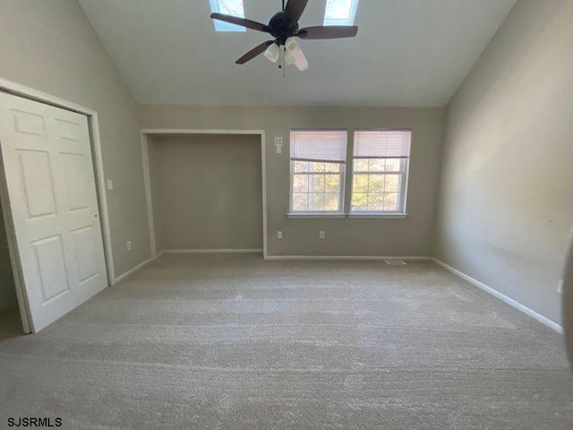 unfurnished bedroom with lofted ceiling, light colored carpet, and ceiling fan