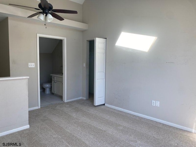 unfurnished room with vaulted ceiling, light colored carpet, and ceiling fan