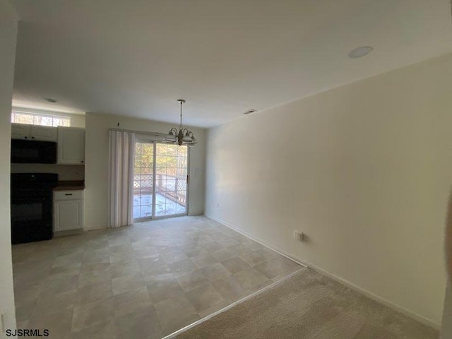 spare room featuring a notable chandelier