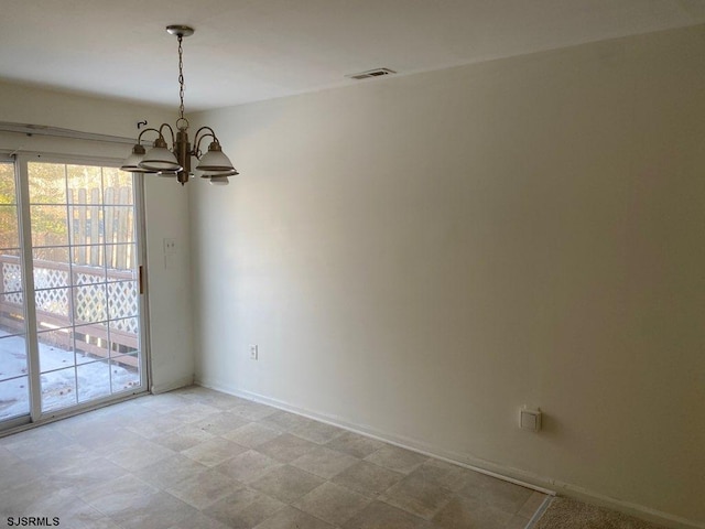 empty room featuring a notable chandelier