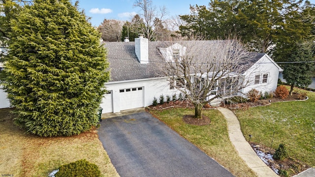 cape cod-style house with a garage and a front yard