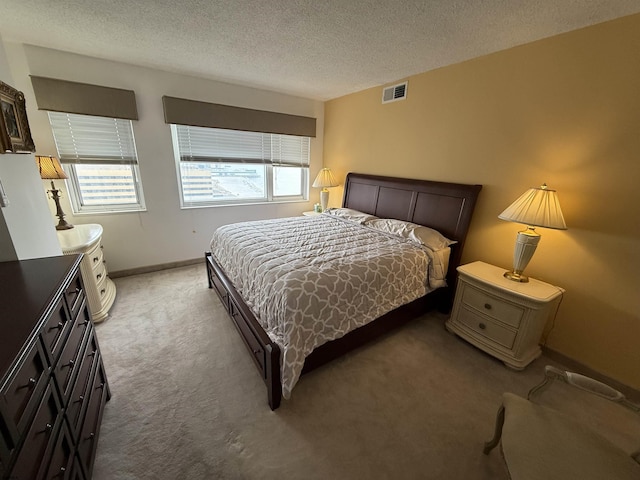 carpeted bedroom featuring a textured ceiling