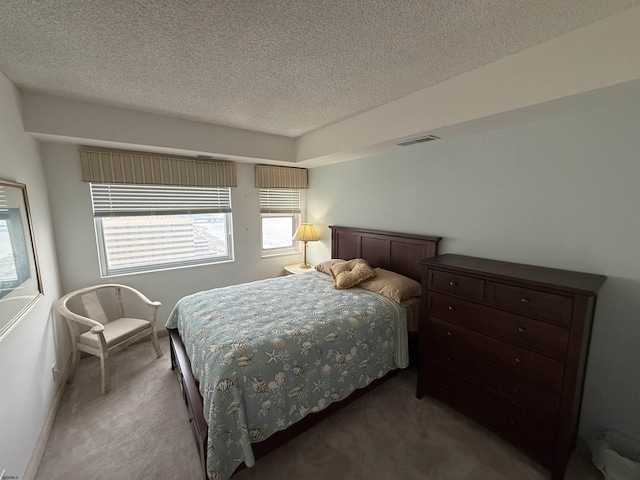 carpeted bedroom featuring a textured ceiling