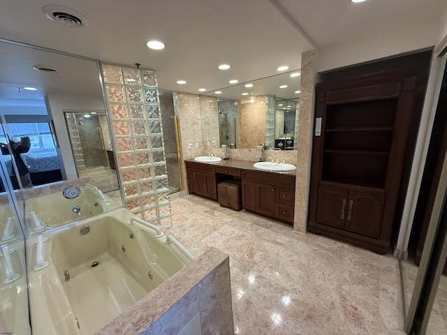 bathroom featuring vanity, separate shower and tub, and tile walls