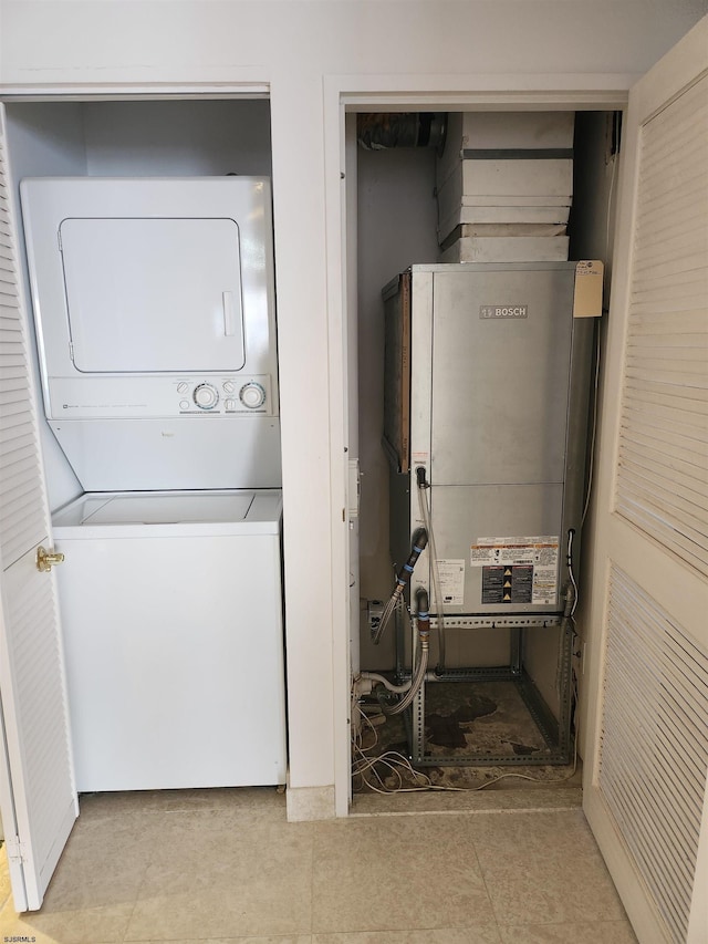 laundry room with stacked washer / dryer