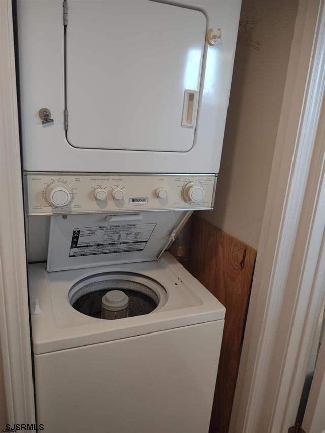 washroom with stacked washer and clothes dryer