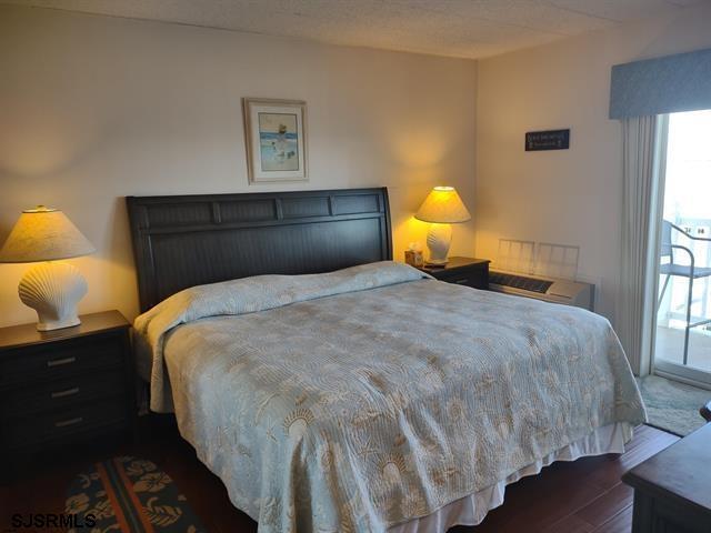 bedroom with dark hardwood / wood-style flooring