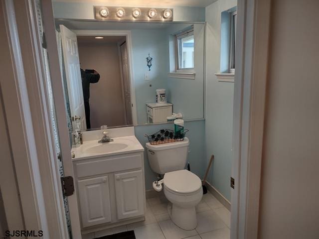 bathroom with vanity, tile patterned floors, and toilet