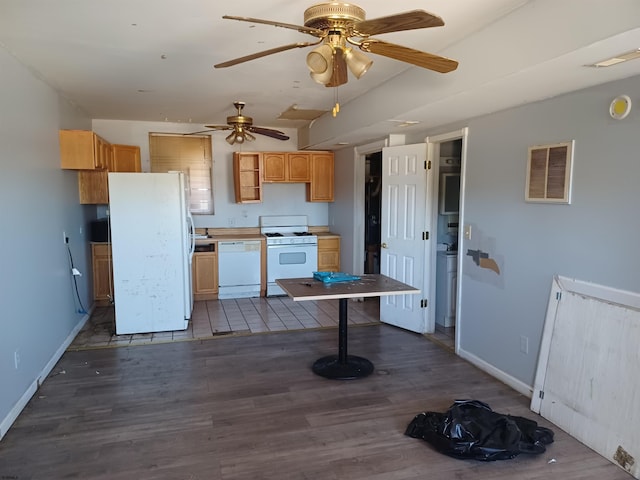 kitchen with white appliances, dark hardwood / wood-style floors, and light brown cabinets