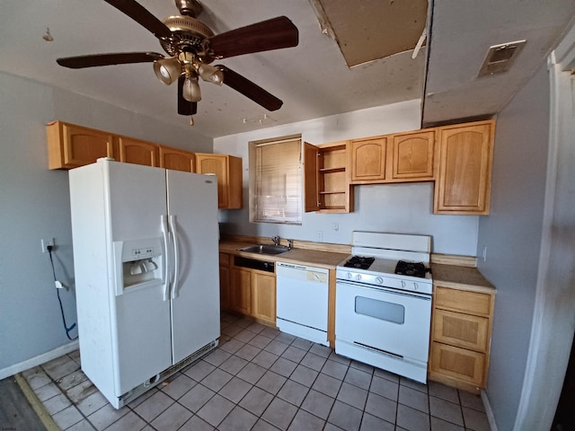 kitchen featuring light brown cabinets, sink, light tile patterned floors, and white appliances