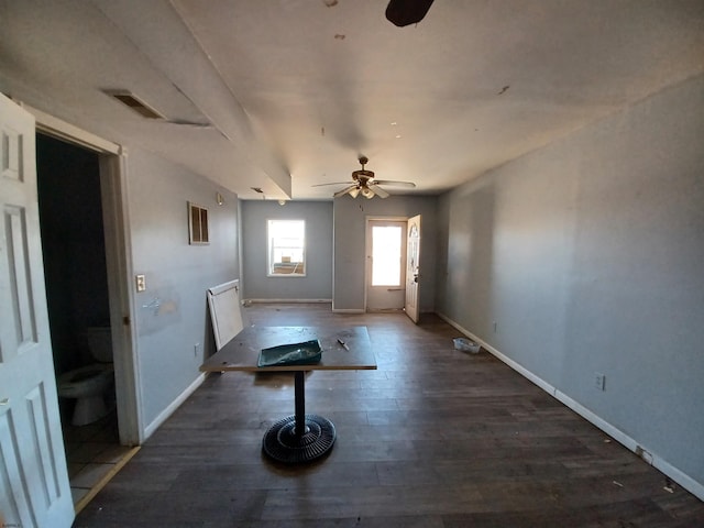 unfurnished dining area with dark hardwood / wood-style flooring and ceiling fan