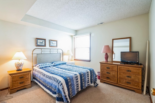 carpeted bedroom featuring a textured ceiling