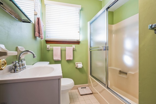 full bathroom featuring tile patterned flooring, enclosed tub / shower combo, vanity, and toilet