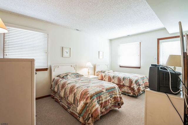 carpeted bedroom with a textured ceiling