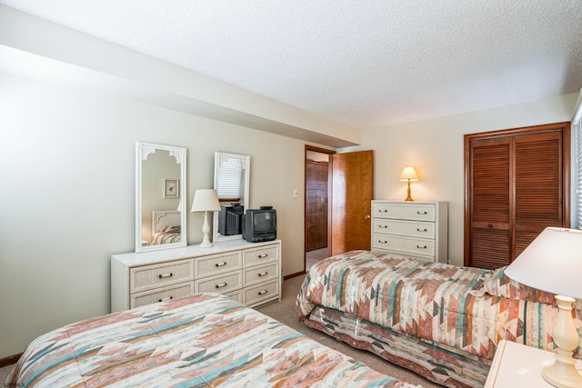 carpeted bedroom featuring a textured ceiling and a closet