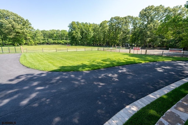 view of property's community with a yard and a rural view