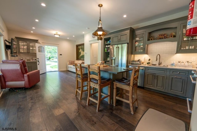 dining room with dark hardwood / wood-style flooring and indoor wet bar