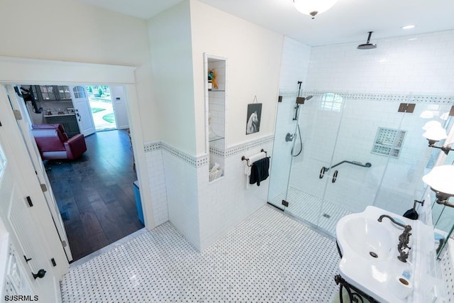 bathroom featuring tile walls and an enclosed shower