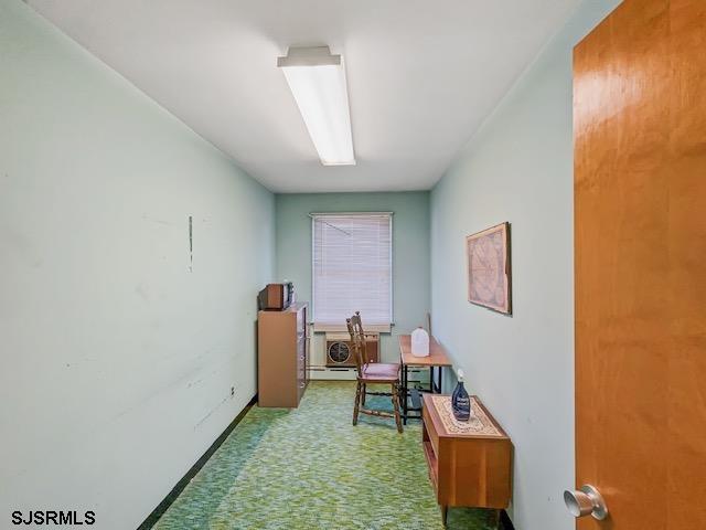 hallway featuring light colored carpet