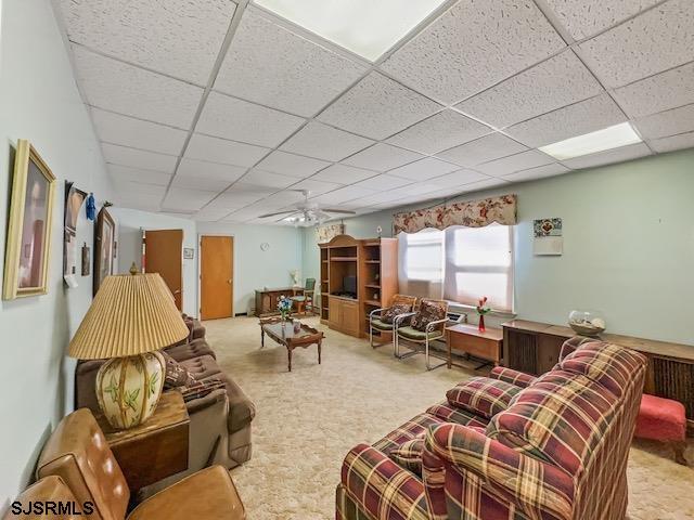 living room featuring a paneled ceiling