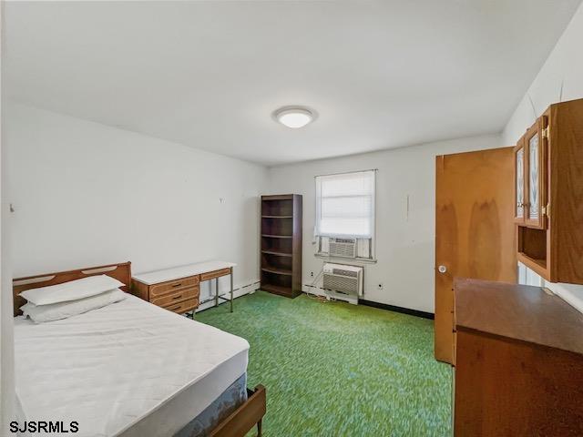 carpeted bedroom featuring cooling unit and an AC wall unit