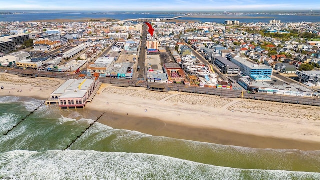 drone / aerial view featuring a view of the beach and a water view