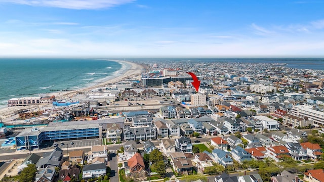 aerial view with a water view and a view of the beach