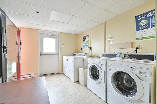 laundry room with a baseboard radiator and washer and dryer