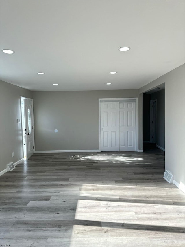 empty room with hardwood / wood-style floors