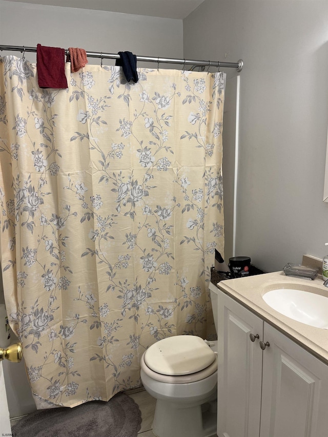 bathroom featuring vanity, toilet, and a shower with shower curtain