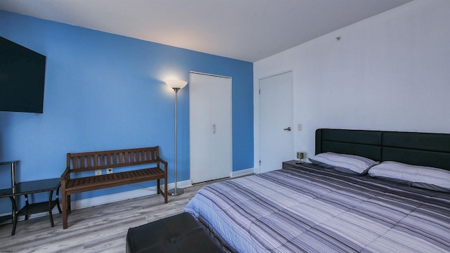 bedroom with hardwood / wood-style flooring and a closet