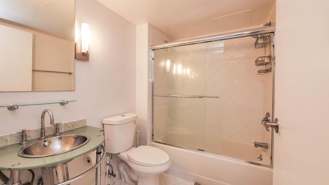 full bathroom featuring tile patterned flooring, sink, enclosed tub / shower combo, and toilet