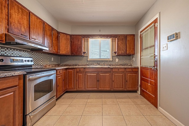 kitchen featuring electric stove, sink, decorative backsplash, and light tile patterned floors