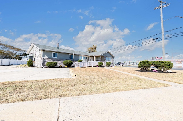 view of front of home with a porch and a front yard