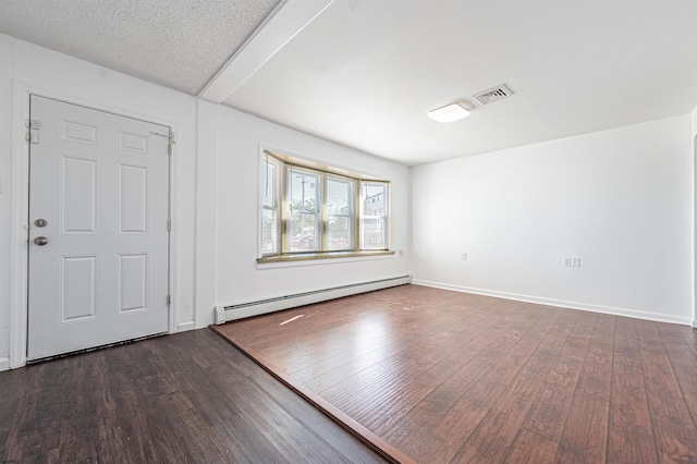 entryway featuring dark hardwood / wood-style flooring, a textured ceiling, and a baseboard heating unit