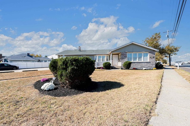 ranch-style home with a front lawn