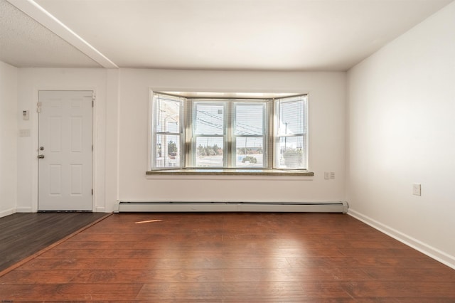 entrance foyer with a baseboard heating unit and dark wood-type flooring