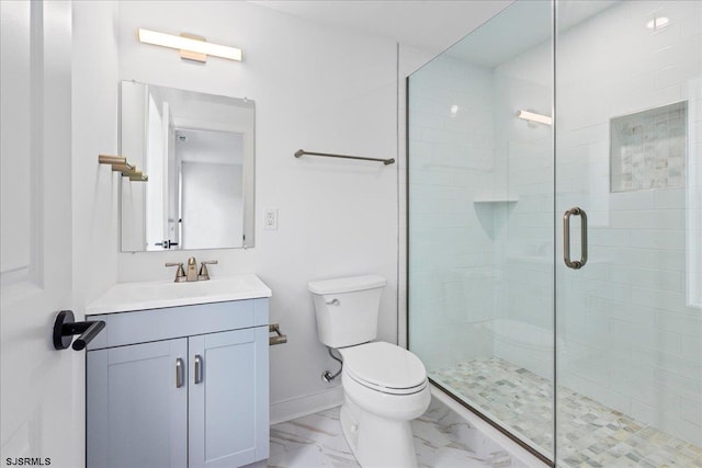 bathroom featuring vanity, an enclosed shower, and toilet